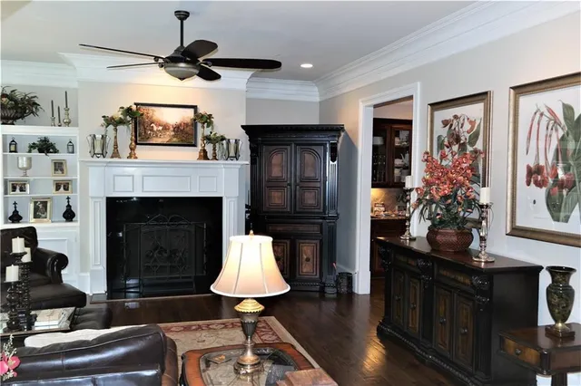 a living room with furniture fireplace and flat screen tv