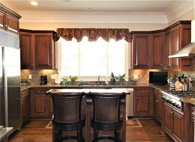 a kitchen with a sink stove and cabinets