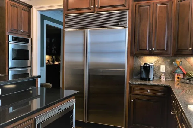 a kitchen with a refrigerator and a sink