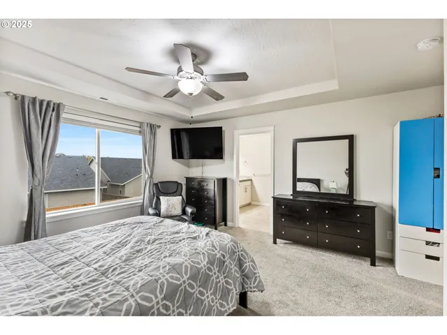 a bedroom with a bed and a television