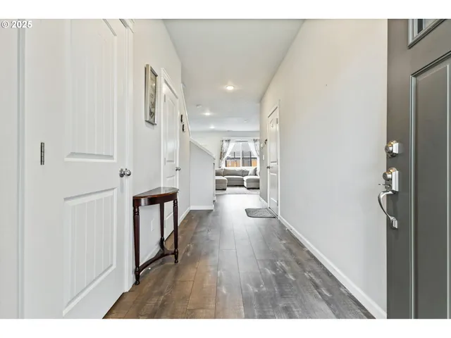 a open kitchen with white cabinets and stainless steel appliances