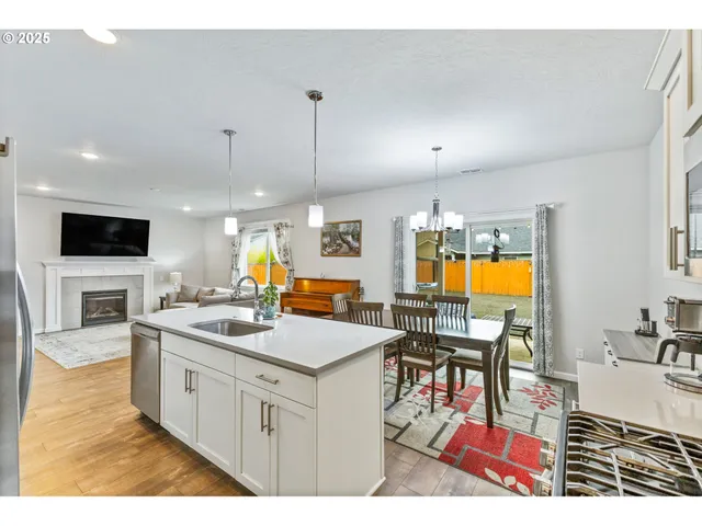 a kitchen with a sink appliances and cabinets