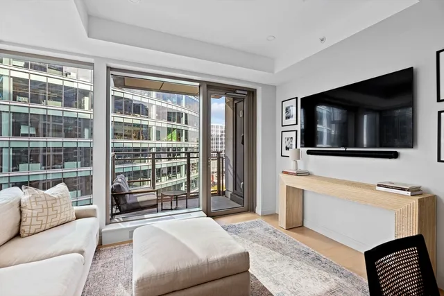 a living room with furniture tv and a flat screen tv