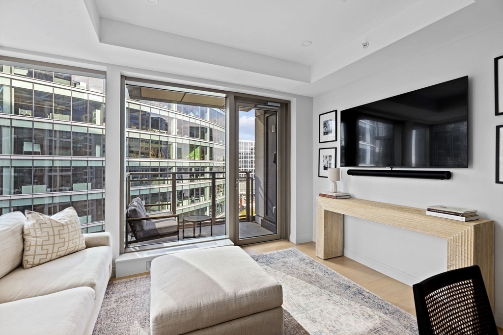 133 Seaport Boulevard, Unit 1603 Boston, MA 02210 - Photo 11 of 32 a living room with furniture tv and a flat screen tv