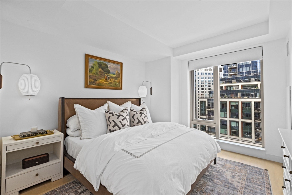 133 Seaport Boulevard, Unit 1603 Boston, MA 02210 - Photo 14 of 32 a bedroom with a bed and a window