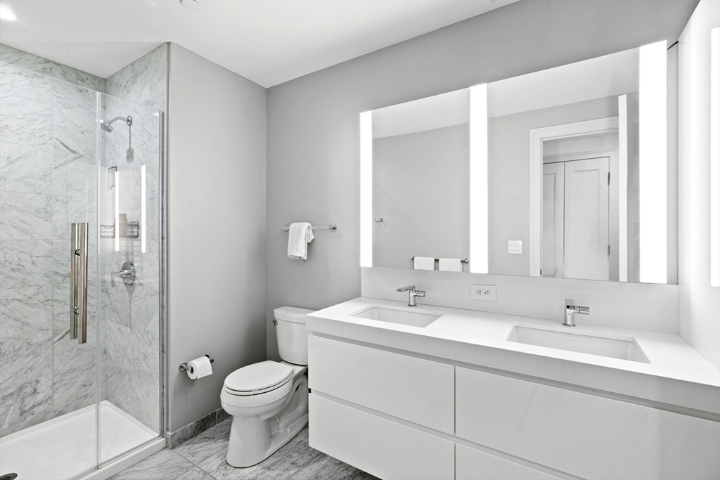 133 Seaport Boulevard, Unit 1603 Boston, MA 02210 - Photo 18 of 32 a bathroom with a sink toilet and shower