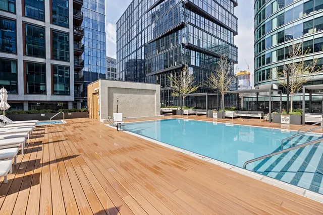 a living room with furniture large window and a table