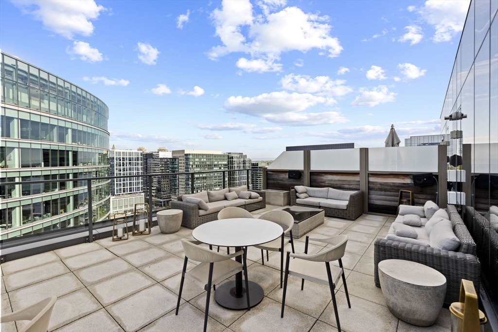 133 Seaport Boulevard, Unit 1603 Boston, MA 02210 - Photo 29 of 32 a view of a terrace with furniture and a table