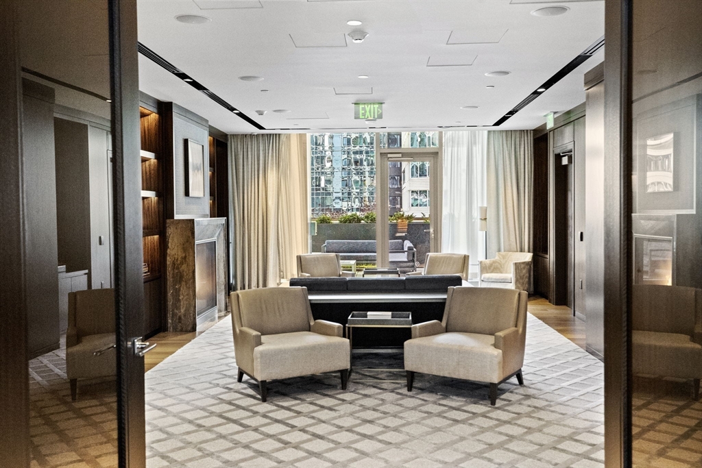 133 Seaport Boulevard, Unit 1603 Boston, MA 02210 - Photo 30 of 32 a living room with furniture and a large window