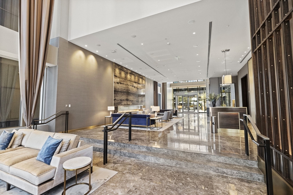 133 Seaport Boulevard, Unit 1603 Boston, MA 02210 - Photo 3 of 32 a living room with furniture and a large window