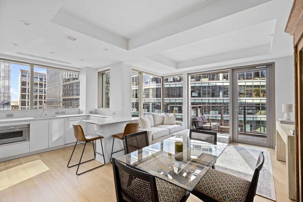 133 Seaport Boulevard, Unit 1603 Boston, MA 02210 - Photo 8 of 32 a view of a dining room with furniture window and wooden floor