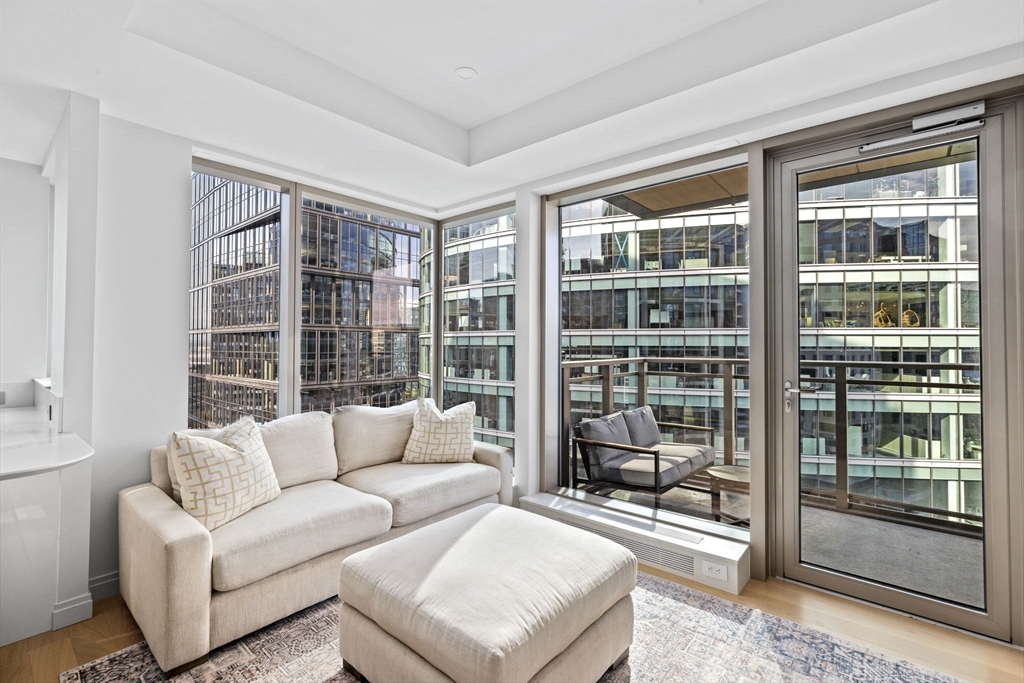 133 Seaport Boulevard, Unit 1603 Boston, MA 02210 - Photo 10 of 32 a living room with furniture and a large window
