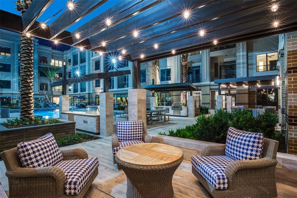 a view of a patio with couches table and chairs and potted plants