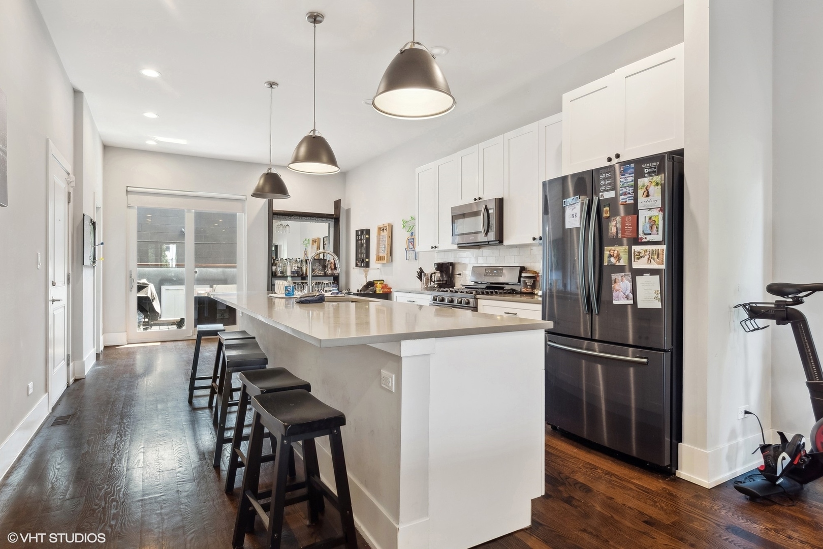 3719 North Seminary Avenue Chicago, IL 60613 - Photo 20 of 26 a kitchen with stainless steel appliances granite countertop a refrigerator a stove a sink dishwasher a dining table and chairs with wooden floor
