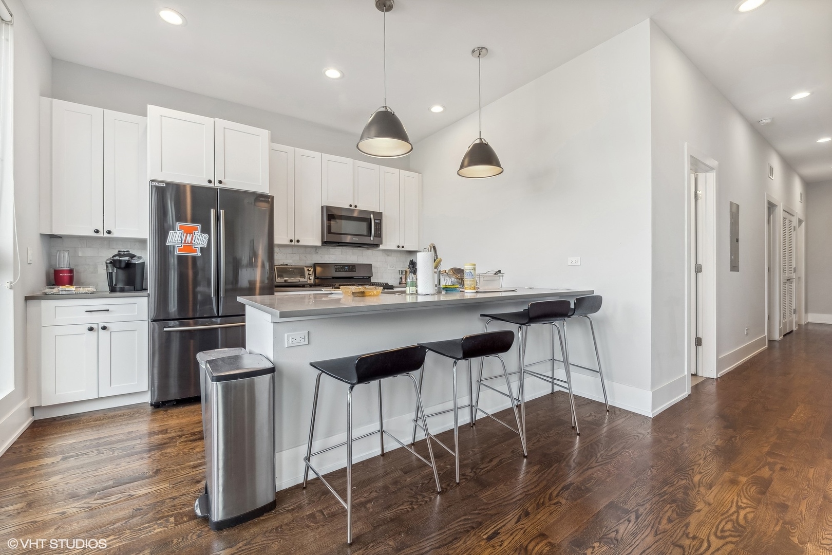 3719 North Seminary Avenue Chicago, IL 60613 - Photo 8 of 26 a kitchen with kitchen island granite countertop a sink a center island a refrigerator and a stove