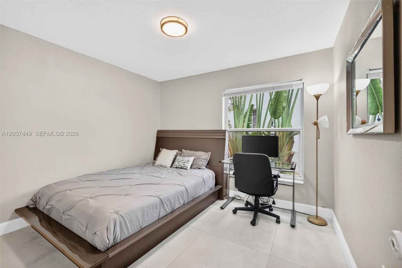 17488 Southwest 28th Court Miramar, FL 33029 - Photo 34 of 50 a bedroom with a bed and window