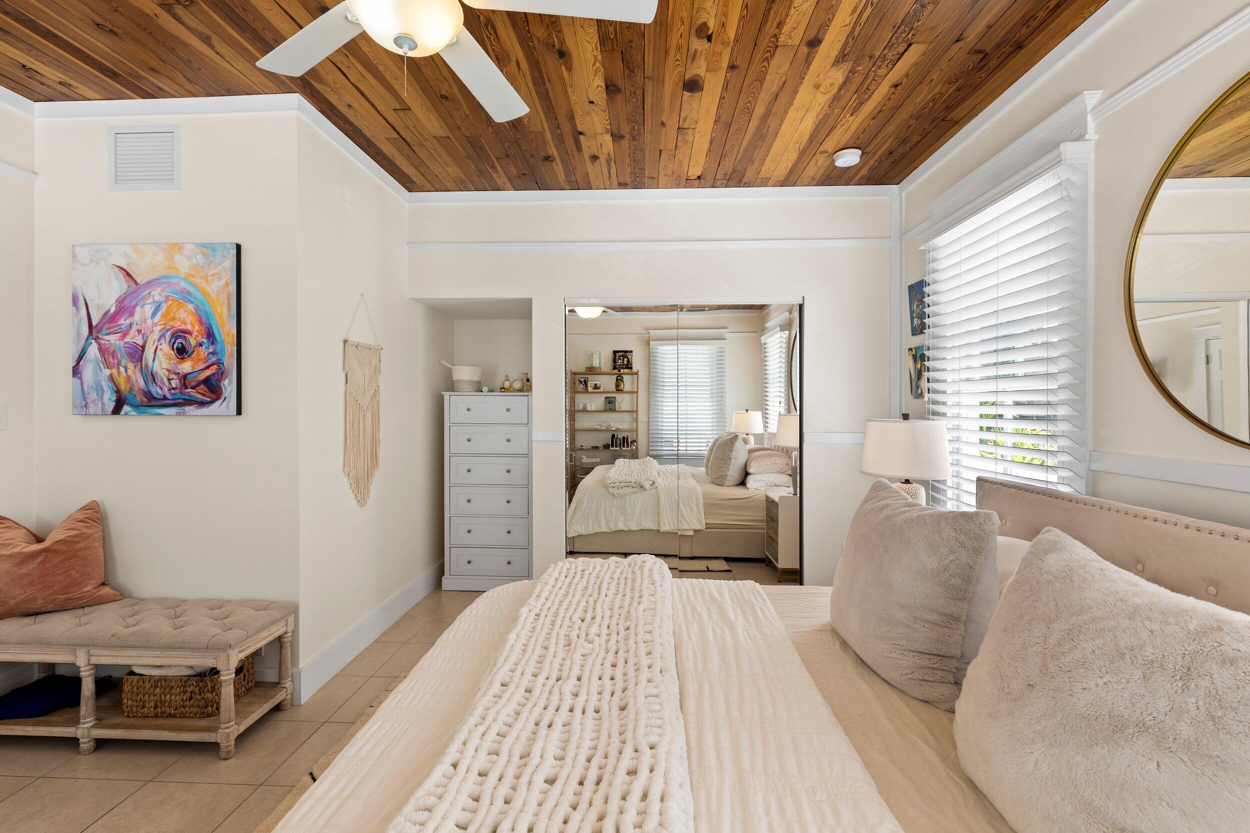 1420 White Street Key West, FL 33040 - Photo 34 of 48 a spacious bedroom with a bed a couch and a window