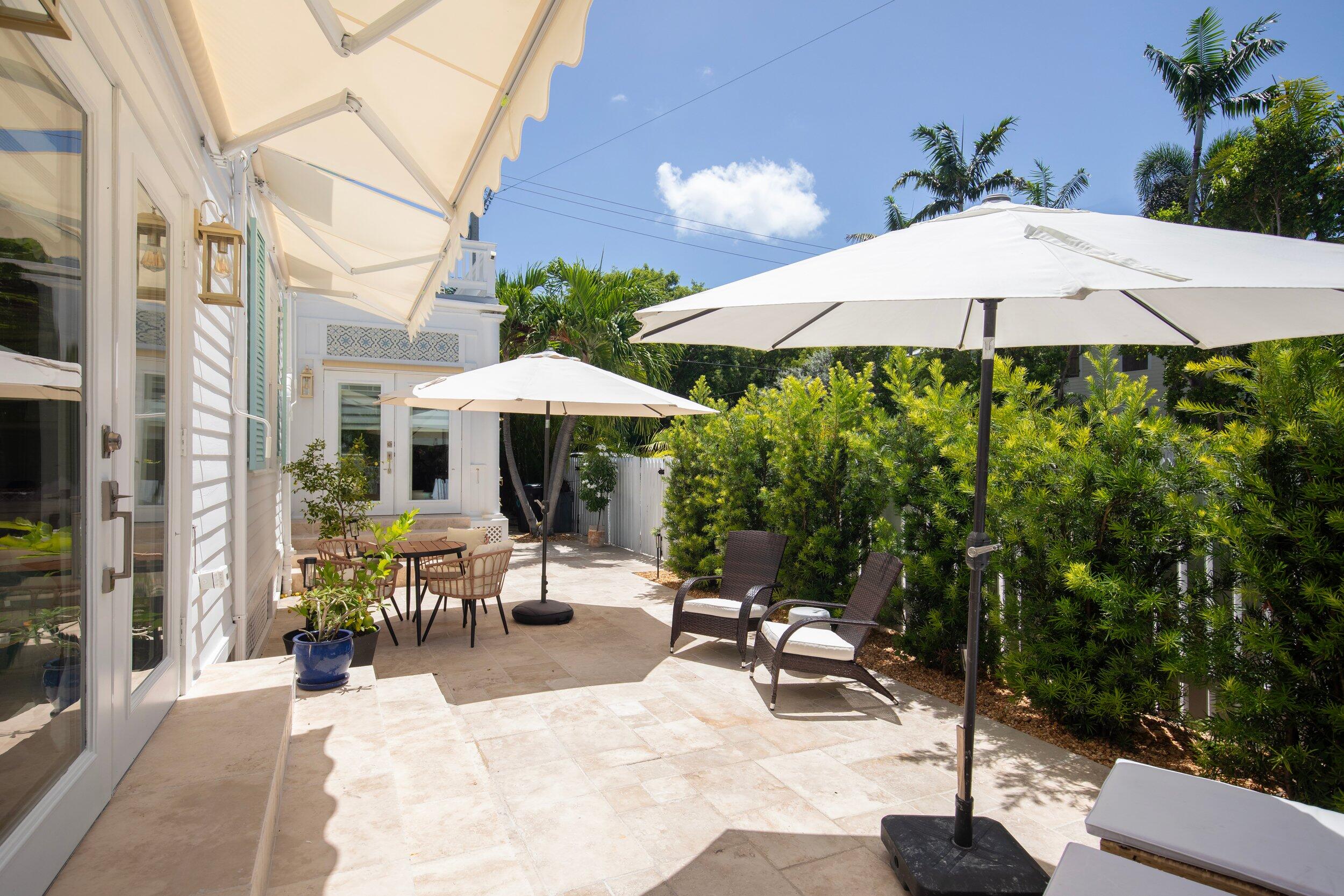 1420 White Street Key West, FL 33040 - Photo 42 of 48 a view of a patio with a table and chairs under an umbrella