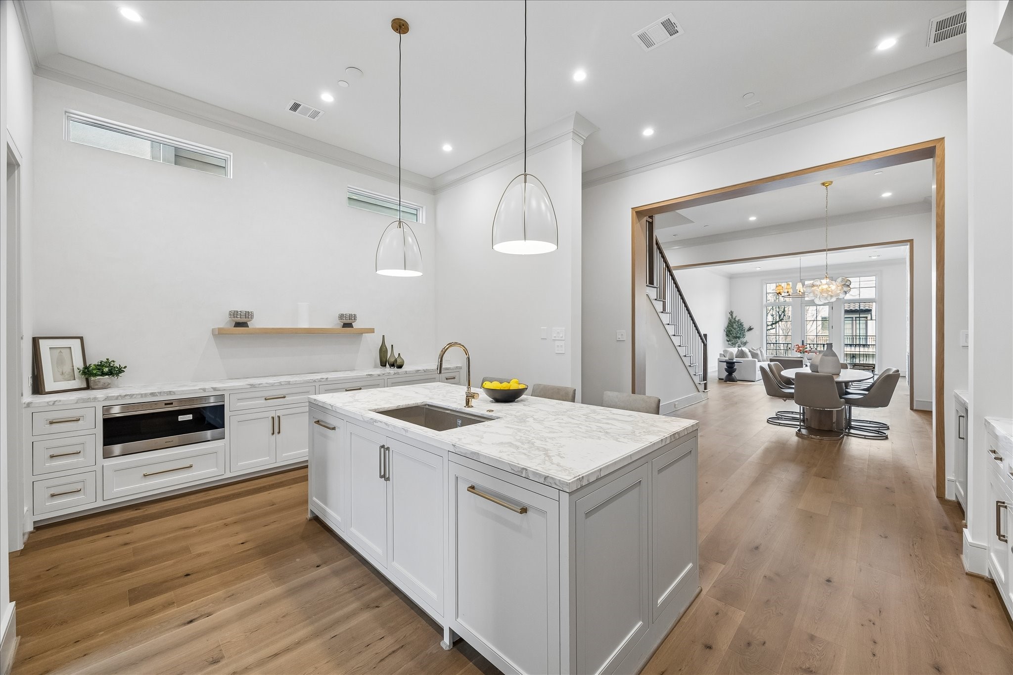 1215 West Pierce Street Houston, TX 77019 - Photo 14 of 37 The dining room separates the family room from the kitchen. The open nature of the room means whatever size table you have, it will integrate perfectly. The whimsical Talia chandelier consists of swirled, artisanal glass orbs suspended on a metal frame, creating a dynamic and sculptural light fixture--the perfect focal point for your dining room.