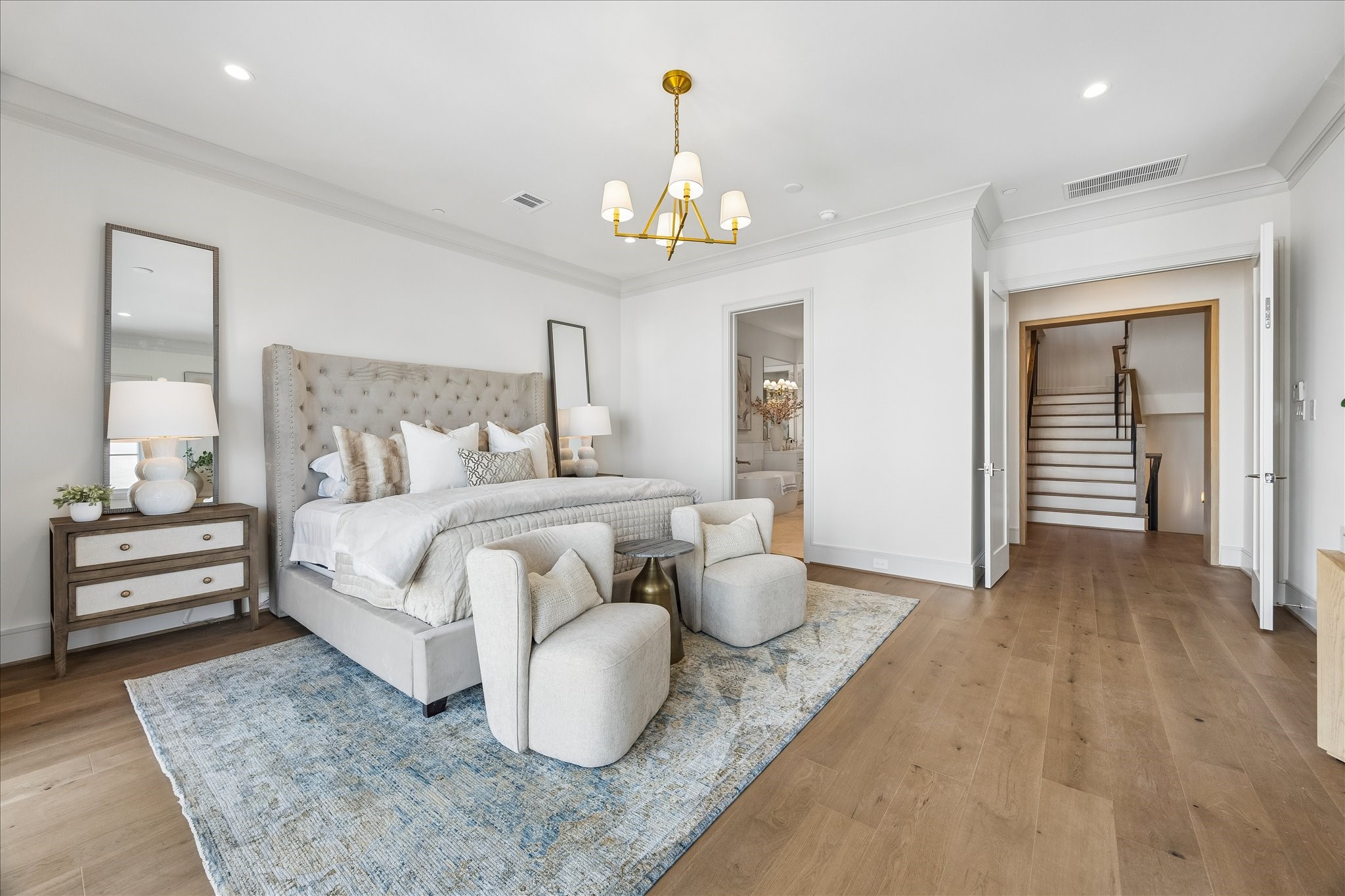 1215 West Pierce Street Houston, TX 77019 - Photo 21 of 37 The primary bedroom has a wide entrance, framed with white oak. It opens onto a luxurious primary bathroom with a truly magnificent primary closet beyond.