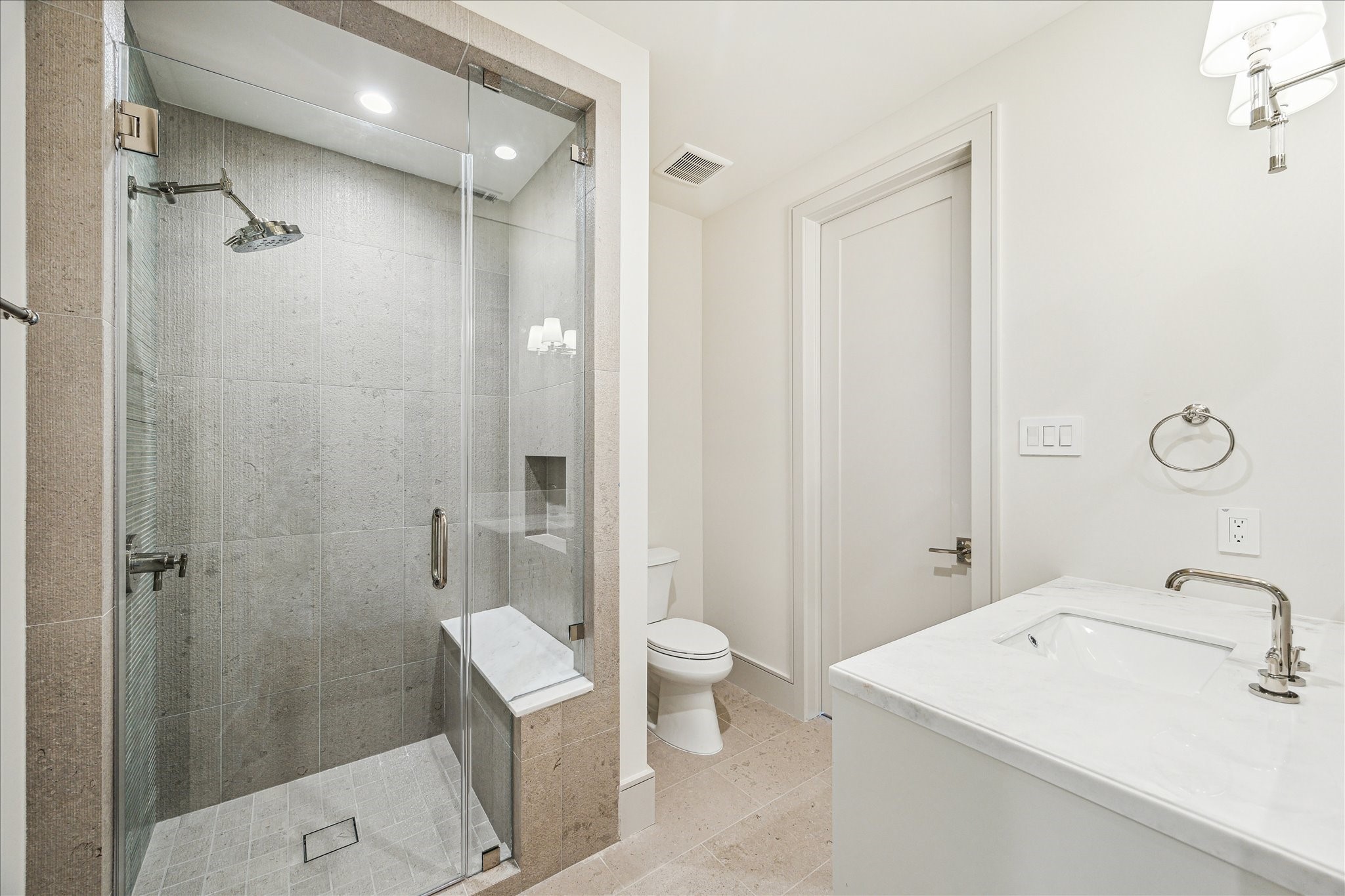 1215 West Pierce Street Houston, TX 77019 - Photo 31 of 37 The fourth floor bathroom has direct access to both the bedroom / theater and the hallway. Here the tile is Lith Antique Creme matte porcelain tile with Potters Bar Agave vertical accent wall.