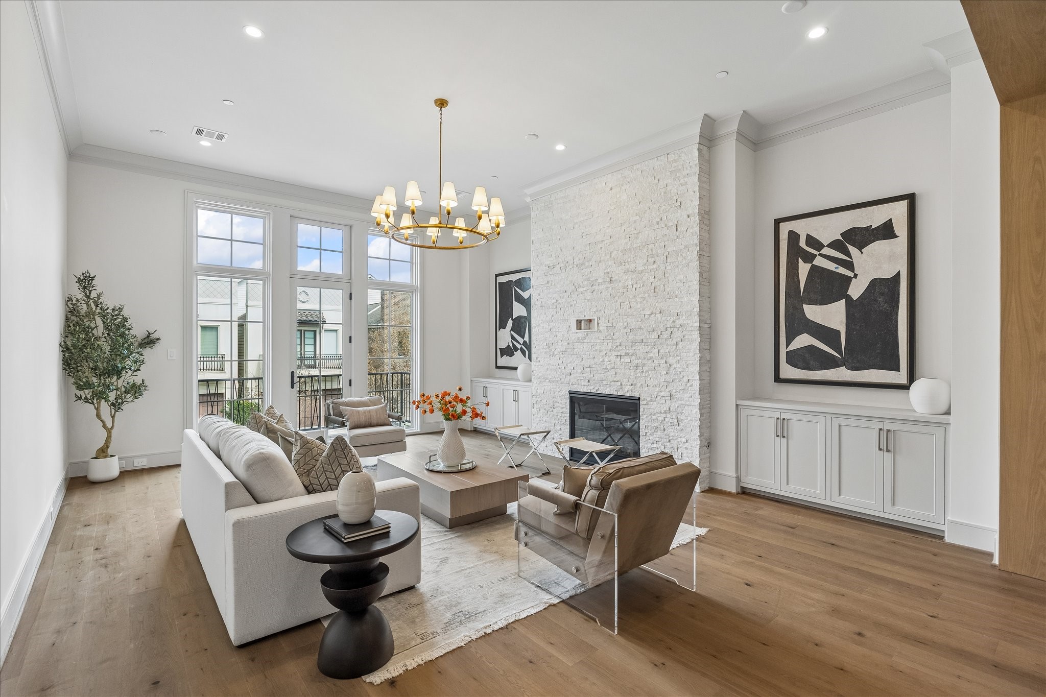 1215 West Pierce Street Houston, TX 77019 - Photo 4 of 37 The fireplace features an IntelliFire Touch Ignition System––user-friendly ambience! The floor-to-ceiling white stack stone fireplace features recessed electrical plug and cable conduit leading to the side cabinet for television mounting.