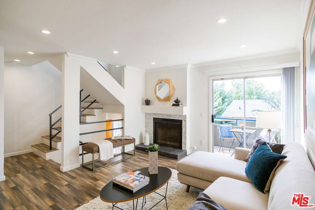 1085 West Kensington Road Los Angeles, CA 90026 - Photo 1 of 23 a living room with furniture fireplace and a large window