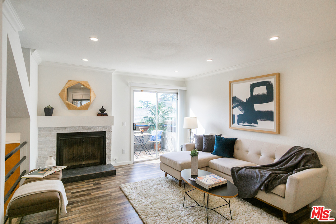 1085 West Kensington Road Los Angeles, CA 90026 - Photo 2 of 23 a living room with furniture and a fireplace
