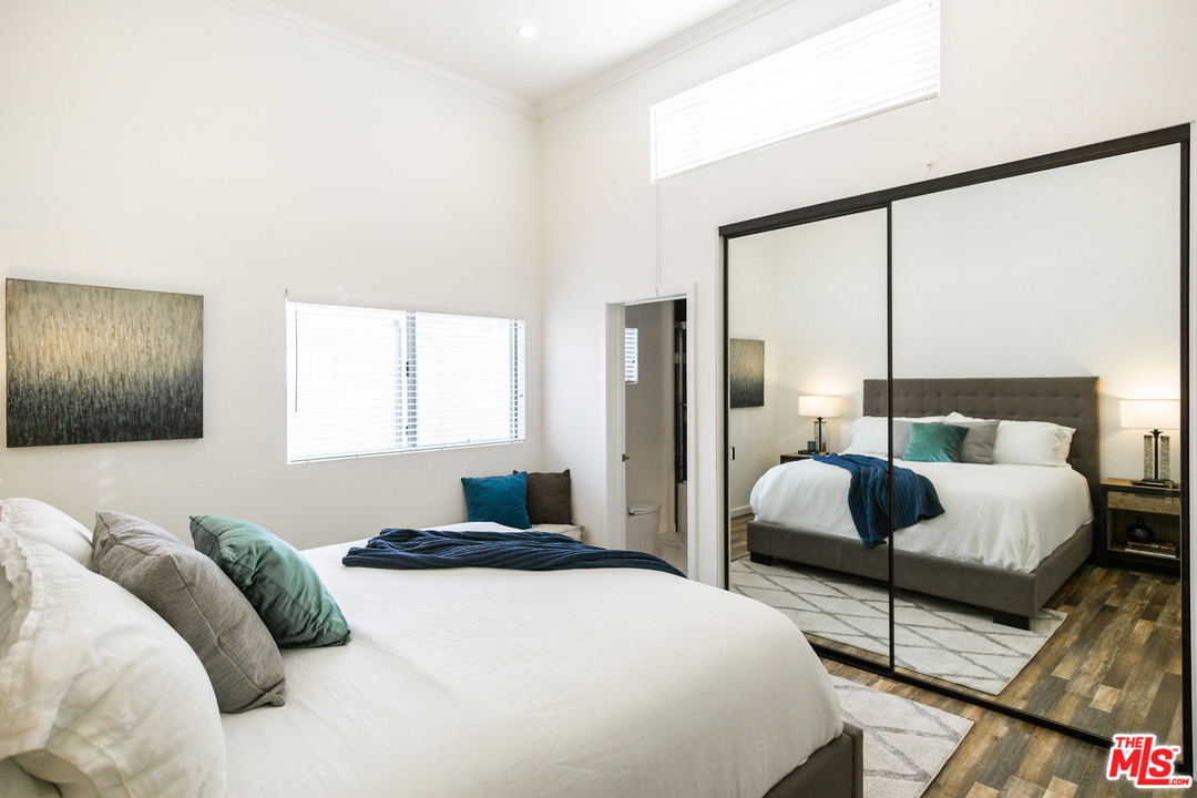 1085 West Kensington Road Los Angeles, CA 90026 - Photo 11 of 23 a bedroom with a bed lamp and window