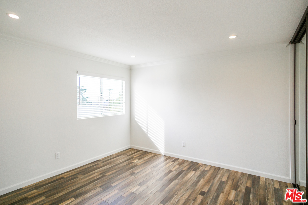 1085 West Kensington Road Los Angeles, CA 90026 - Photo 14 of 23 an empty room with wooden floor and windows