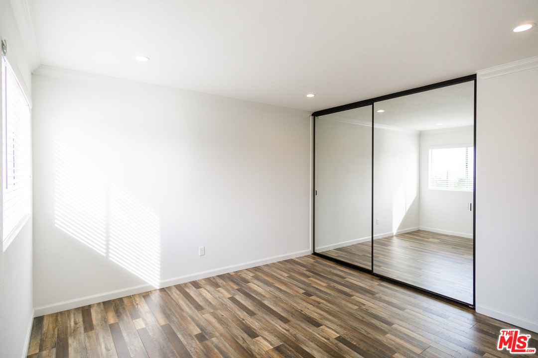 1085 West Kensington Road Los Angeles, CA 90026 - Photo 15 of 23 a view of an empty room with wooden floor