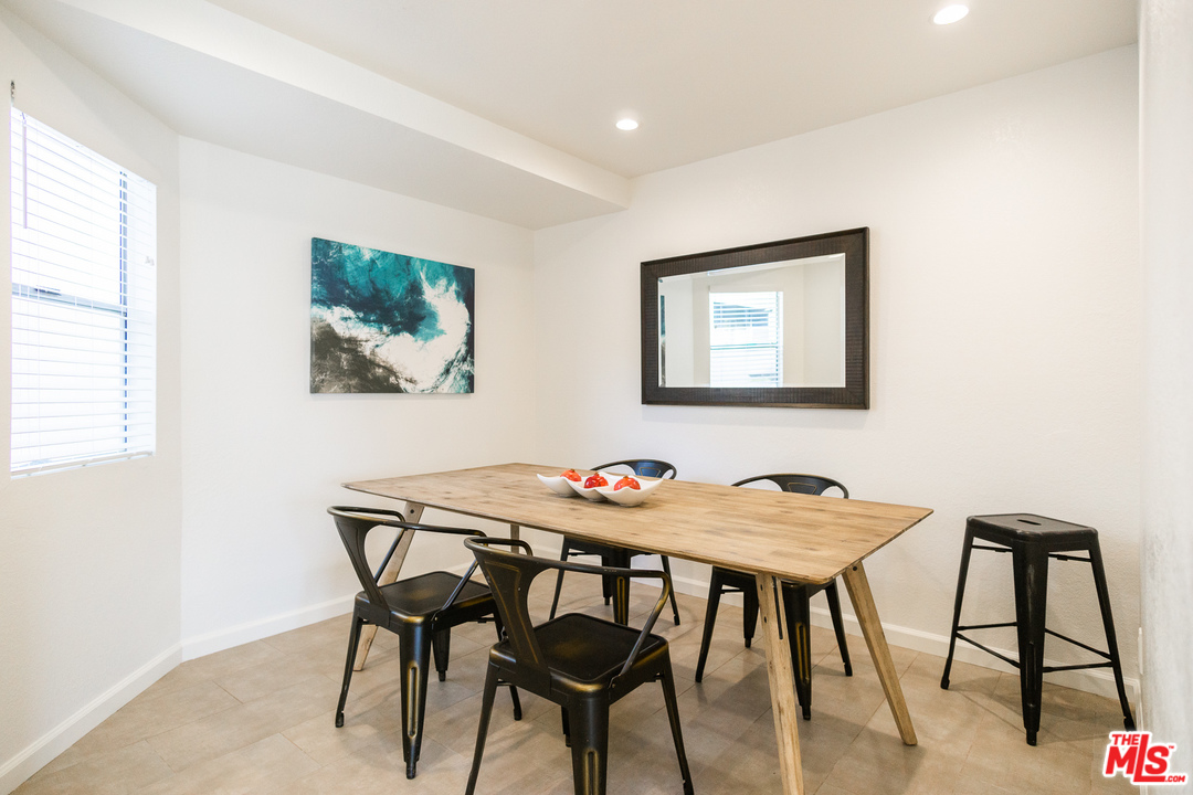 1085 West Kensington Road Los Angeles, CA 90026 - Photo 6 of 23 a view of a dining room with furniture and a potted plant