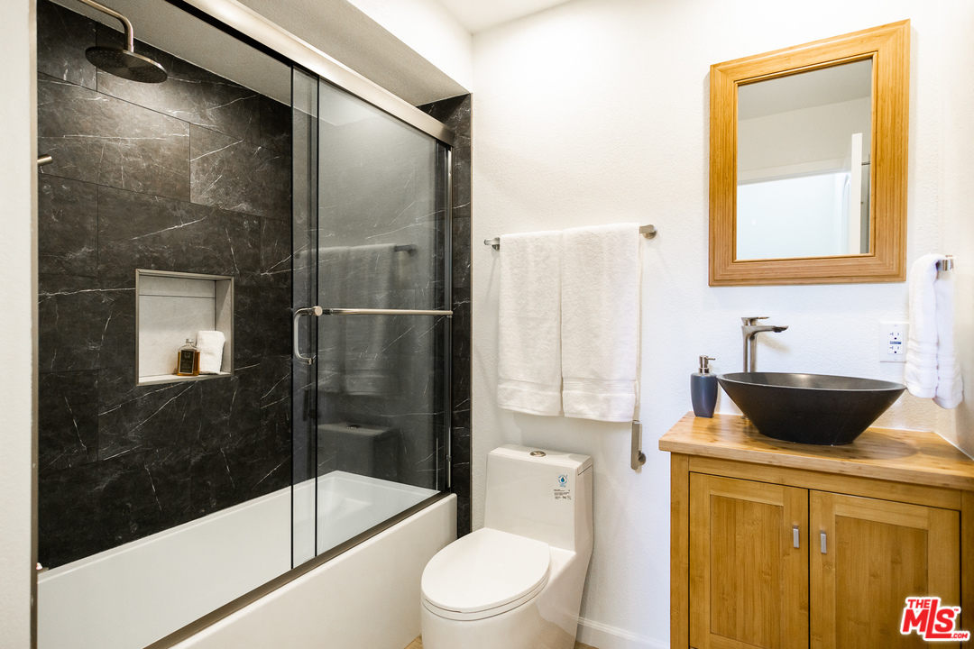 1085 West Kensington Road Los Angeles, CA 90026 - Photo 9 of 23 a bathroom with a granite countertop sink toilet and shower