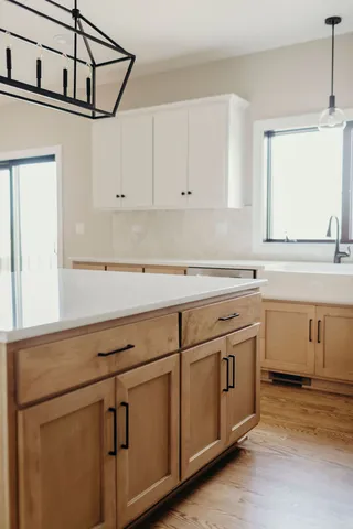 a kitchen with granite countertop white cabinets and white appliances