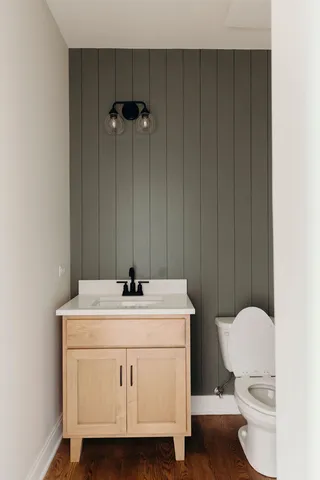 a bathroom with a toilet a sink and a mirror