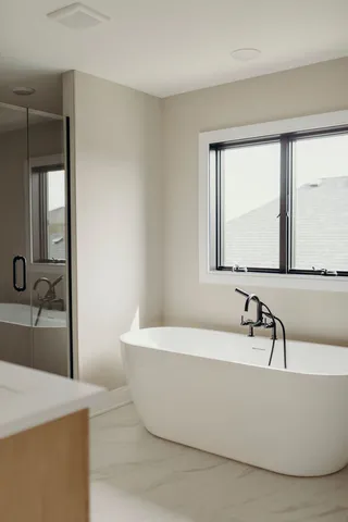a bathroom with a bathtub and a sink
