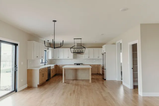 a kitchen with stainless steel appliances granite countertop a sink and cabinets