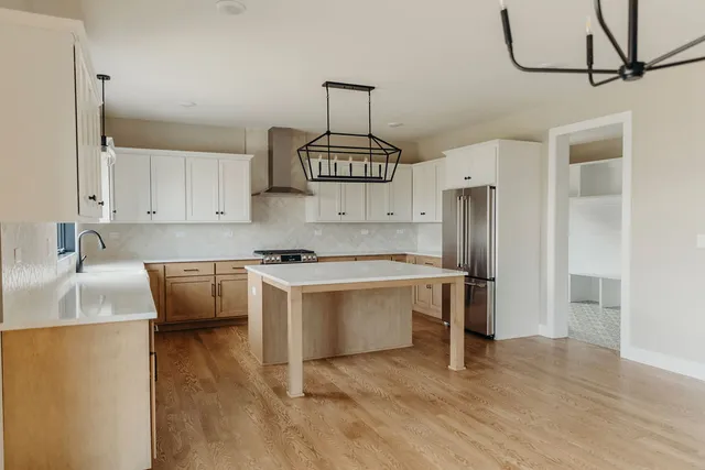 a kitchen with stainless steel appliances a sink stove and refrigerator