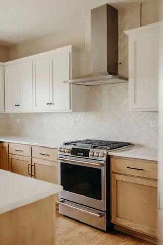 a kitchen with cabinets appliances and wooden floor