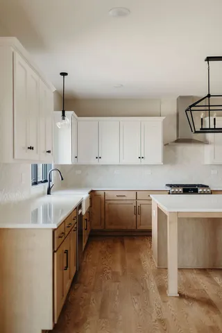 a kitchen that has a sink and a stove in it