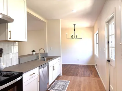 a kitchen with a sink stove and cabinets