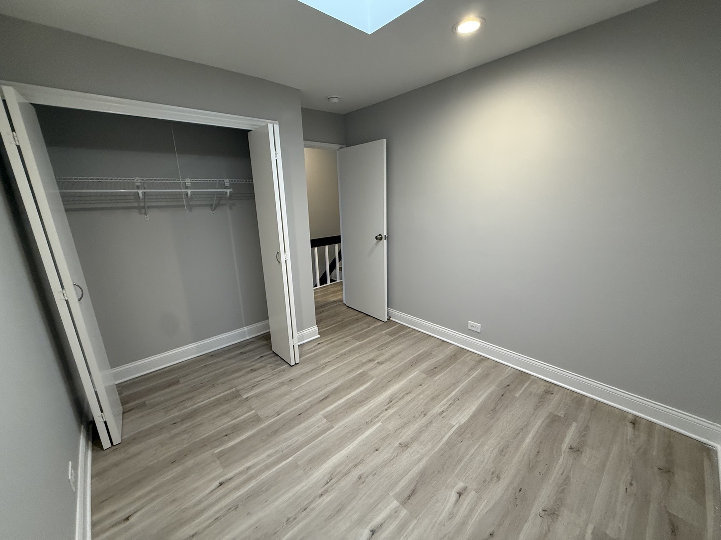 744 West Gordon Terrace, Unit 306 Chicago, IL 60613 - Photo 12 of 13 an empty room with wooden floor and closet