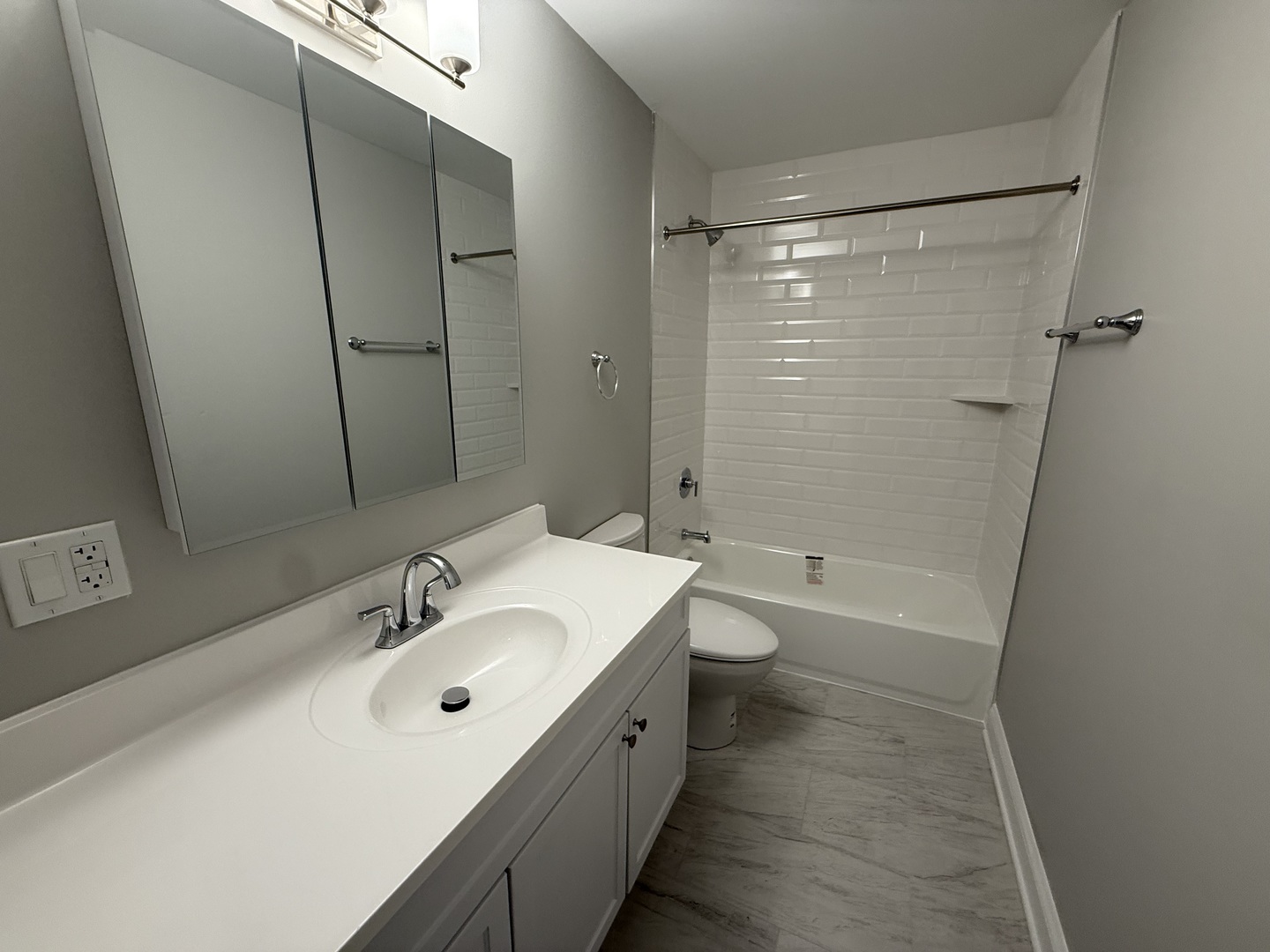 744 West Gordon Terrace, Unit 306 Chicago, IL 60613 - Photo 13 of 13 a bathroom with a double vanity sink toilet mirror and shower