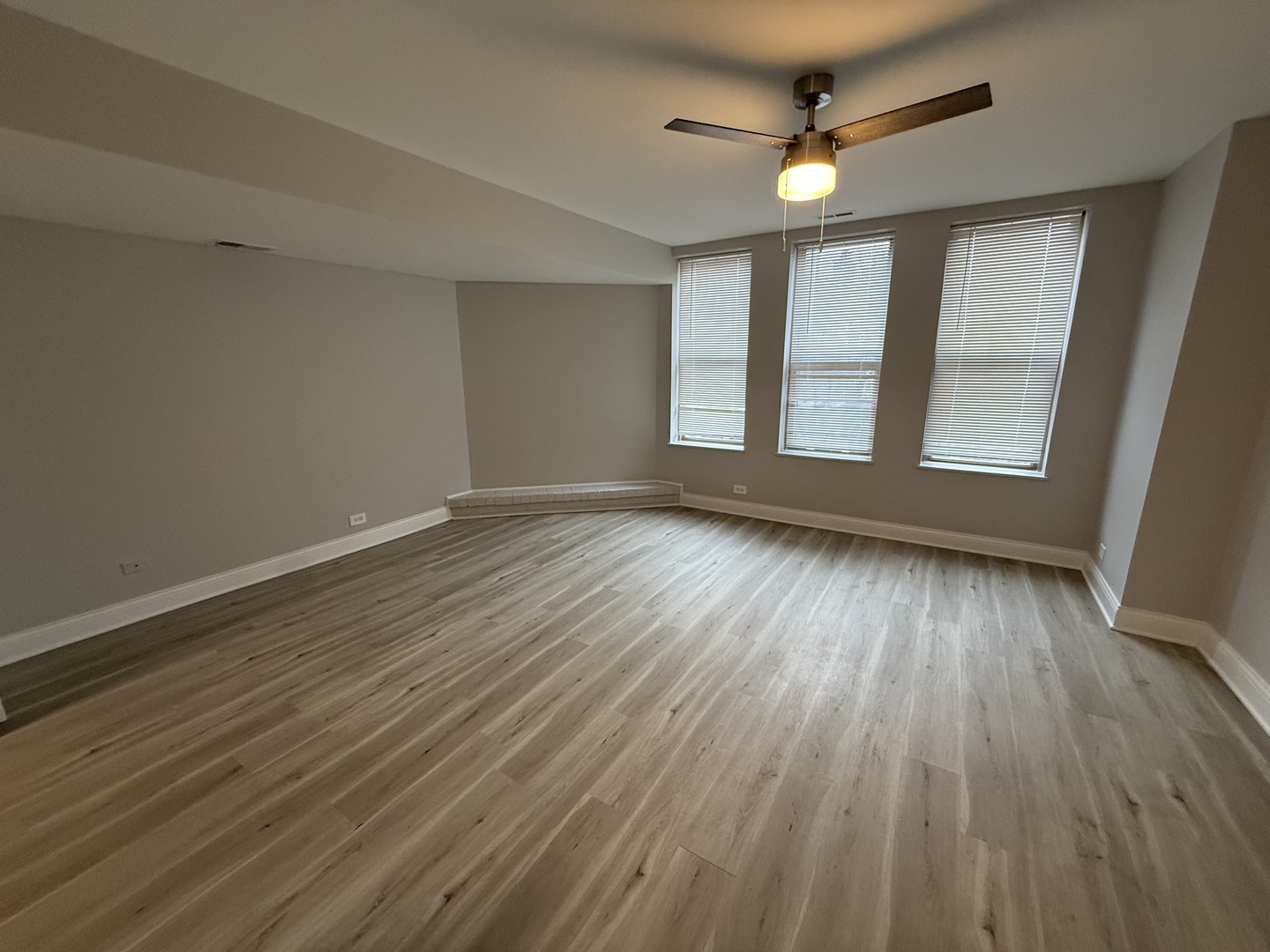 744 West Gordon Terrace, Unit 306 Chicago, IL 60613 - Photo 4 of 13 an empty room with wooden floor and windows