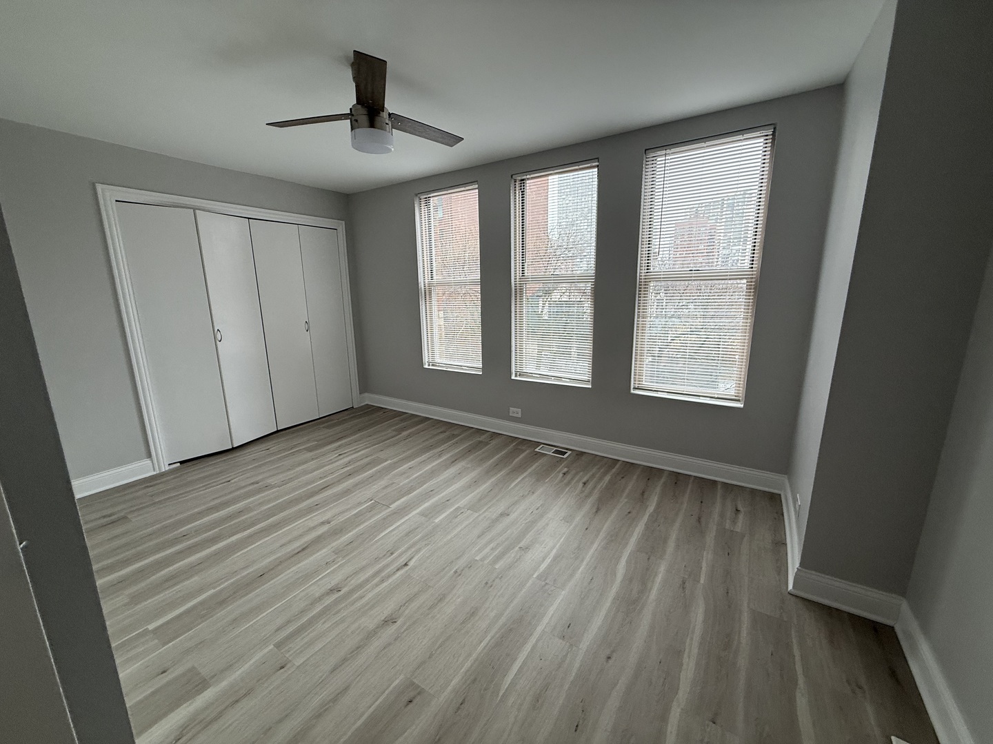 744 West Gordon Terrace, Unit 306 Chicago, IL 60613 - Photo 9 of 13 a view of an empty room with wooden floor and a window