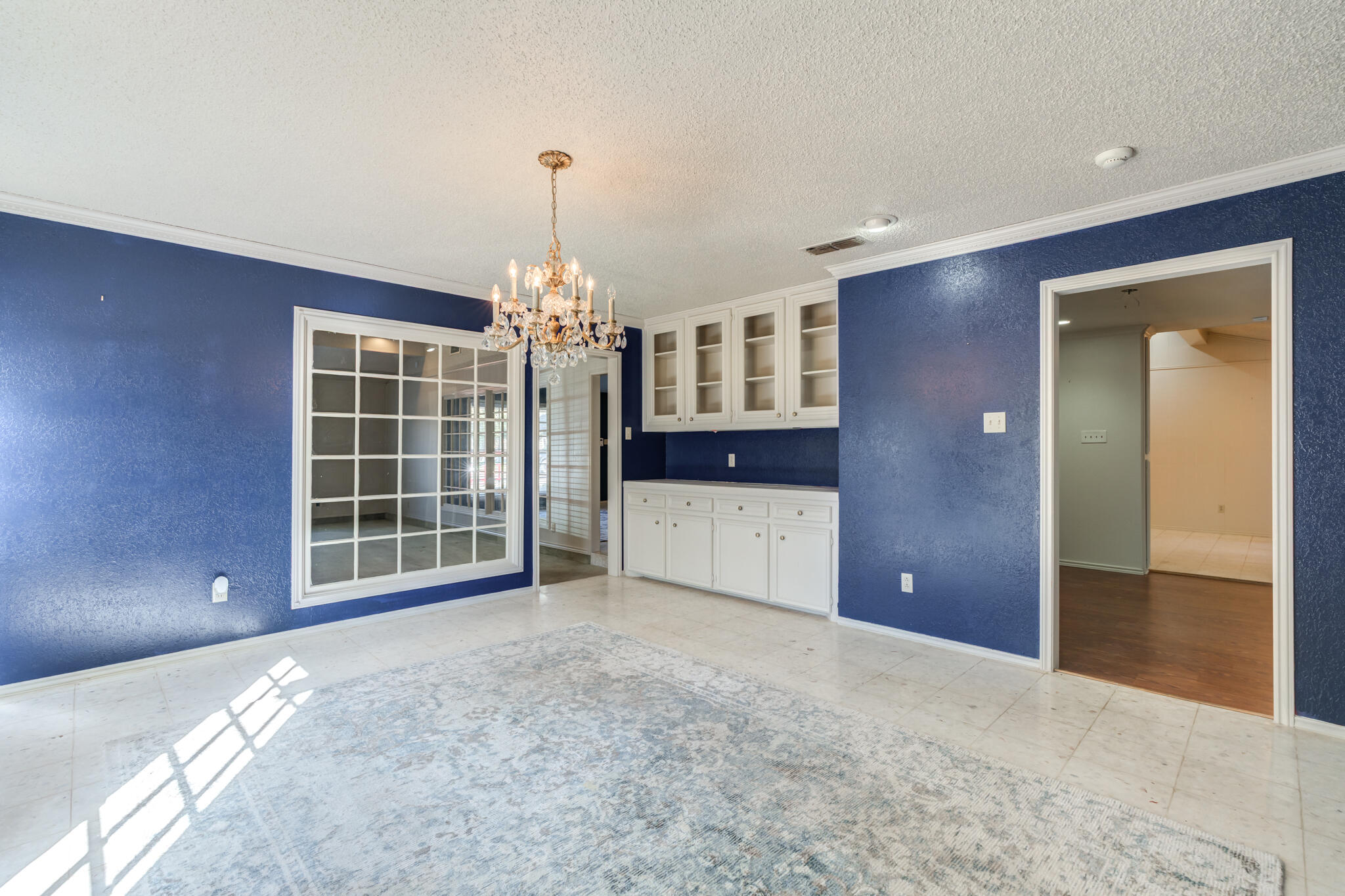 4629 88th Street Lubbock, TX 79424 - Photo 13 of 60 a view of a livingroom with a chandelier fan and windows