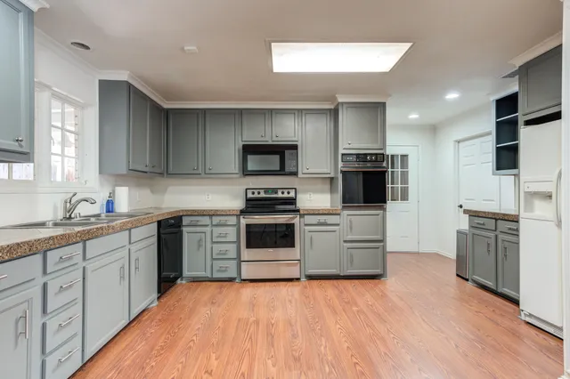 a kitchen with stainless steel appliances a refrigerator and a stove top oven