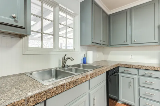 a view of a kitchen cabinets a sink and a wooden floor