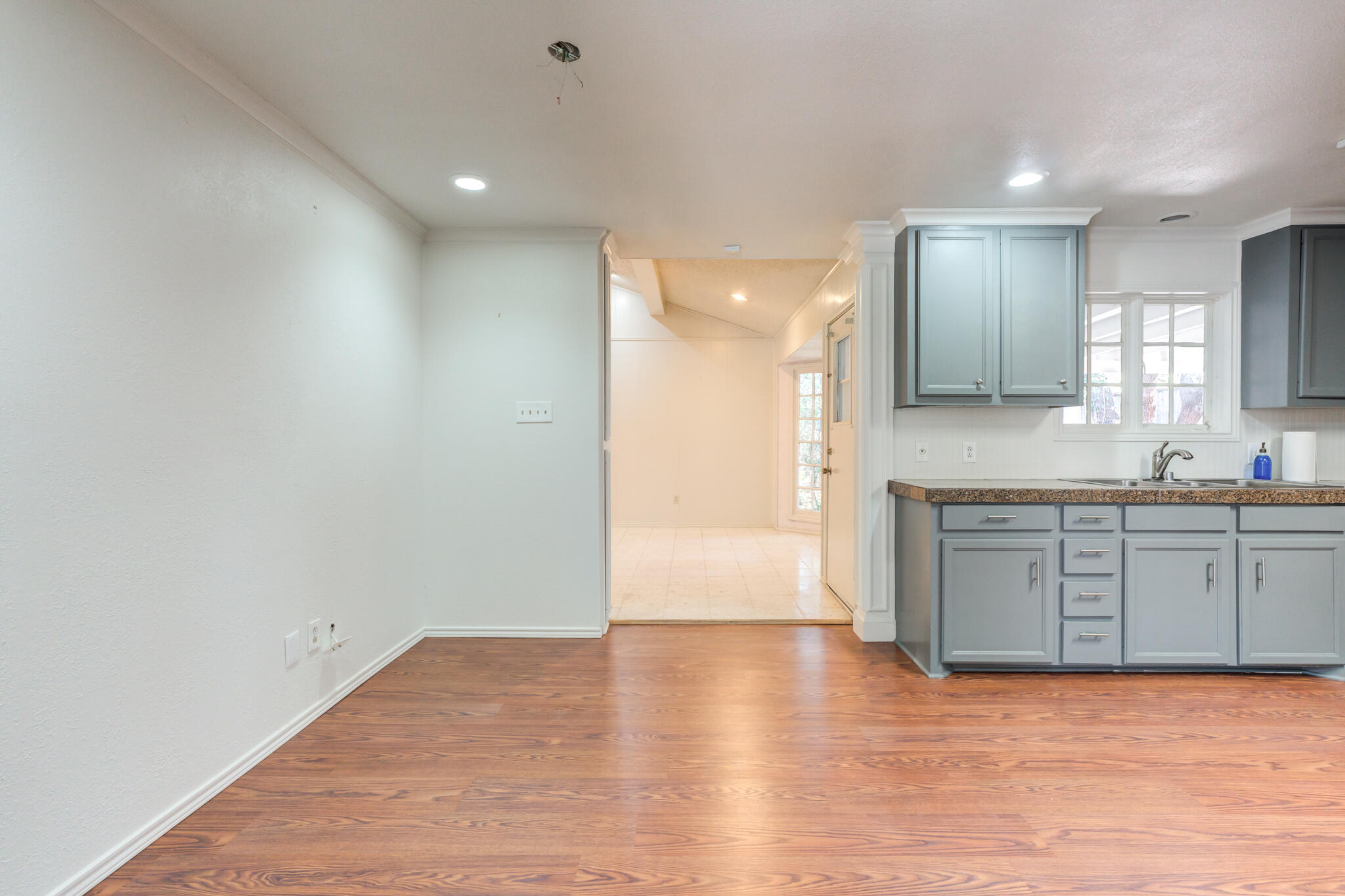 4629 88th Street Lubbock, TX 79424 - Photo 23 of 60 a view of a kitchen cabinets a sink and a wooden floor