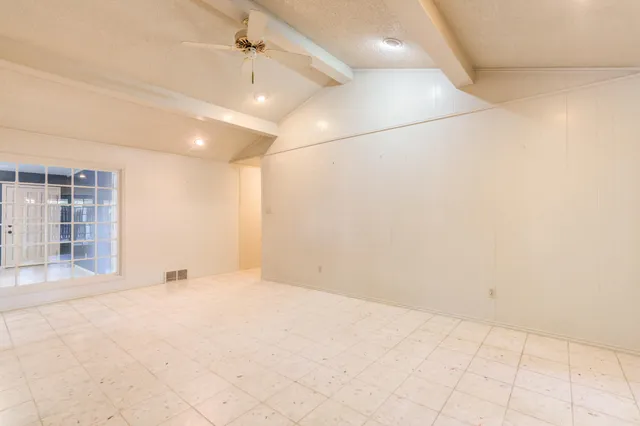 a view of an empty room and a window